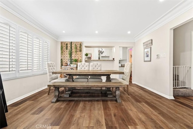 dining area featuring crown molding and hardwood / wood-style floors