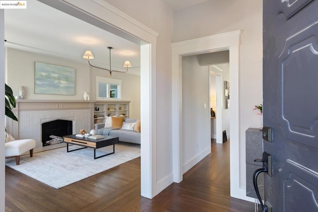 foyer entrance featuring dark hardwood / wood-style floors and a fireplace