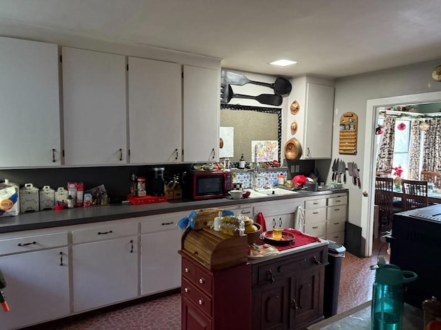 kitchen with white cabinetry and sink