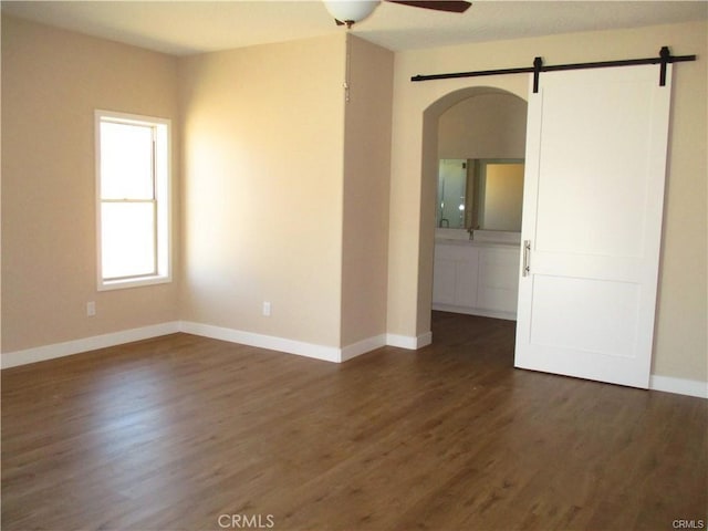 unfurnished room featuring ceiling fan and dark hardwood / wood-style floors