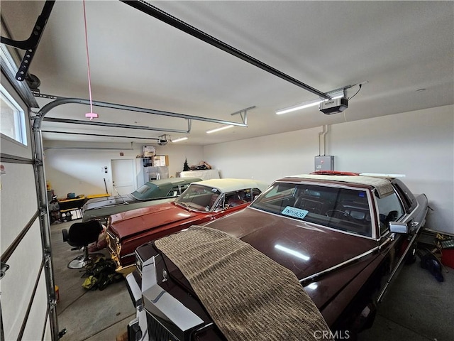 garage featuring a garage door opener and electric panel