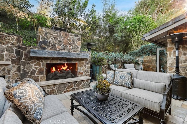 view of patio / terrace with an outdoor living space with a fireplace