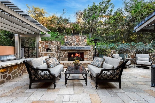 view of patio with an outdoor living space with a fireplace and a pergola