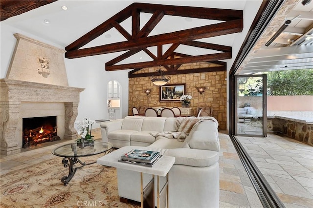 living room featuring beamed ceiling, a premium fireplace, and high vaulted ceiling