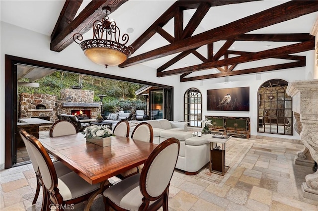 dining area with high vaulted ceiling and beamed ceiling