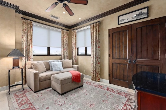 living room featuring crown molding and ceiling fan