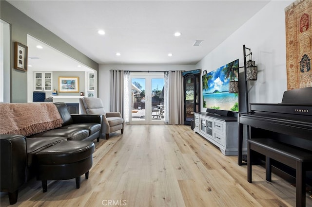 living room featuring light hardwood / wood-style flooring and french doors