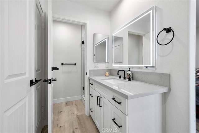 bathroom featuring hardwood / wood-style flooring and vanity