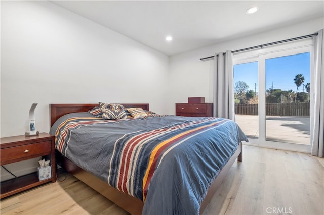 bedroom featuring light hardwood / wood-style floors and access to outside