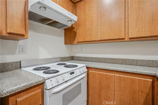 kitchen featuring white range with electric stovetop and light stone counters