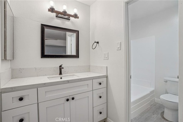 bathroom featuring hardwood / wood-style floors, toilet, and vanity