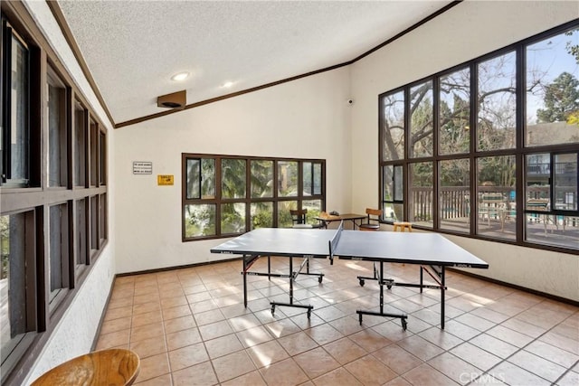 playroom featuring a healthy amount of sunlight, a textured ceiling, light tile patterned floors, and lofted ceiling