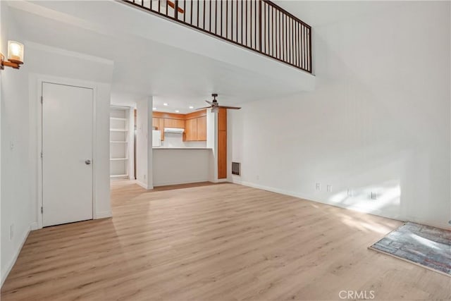 unfurnished living room featuring light hardwood / wood-style floors and ceiling fan