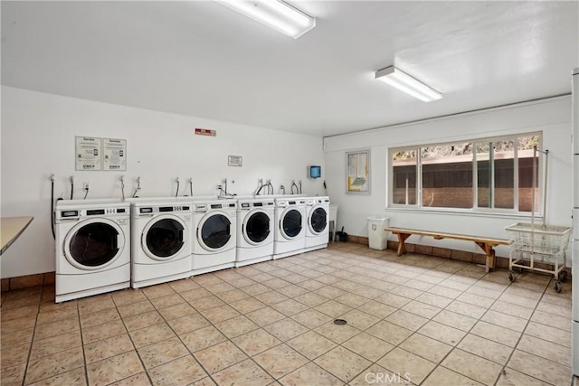 laundry area with light tile patterned flooring and independent washer and dryer