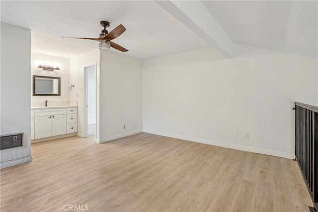 unfurnished living room featuring light hardwood / wood-style floors, sink, ceiling fan, and beamed ceiling