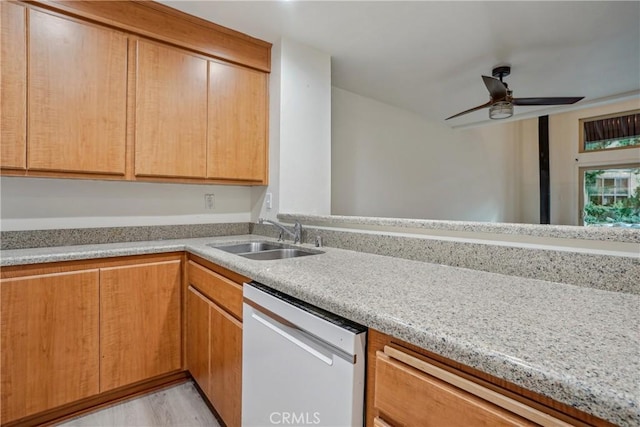 kitchen with light hardwood / wood-style floors, light stone countertops, stainless steel dishwasher, sink, and ceiling fan