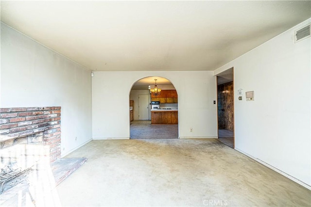 unfurnished living room with a chandelier