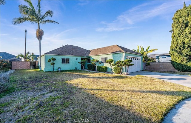 view of front of property with a garage and a front lawn