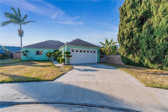 single story home featuring a front yard and a garage