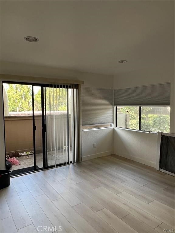 spare room with light hardwood / wood-style floors