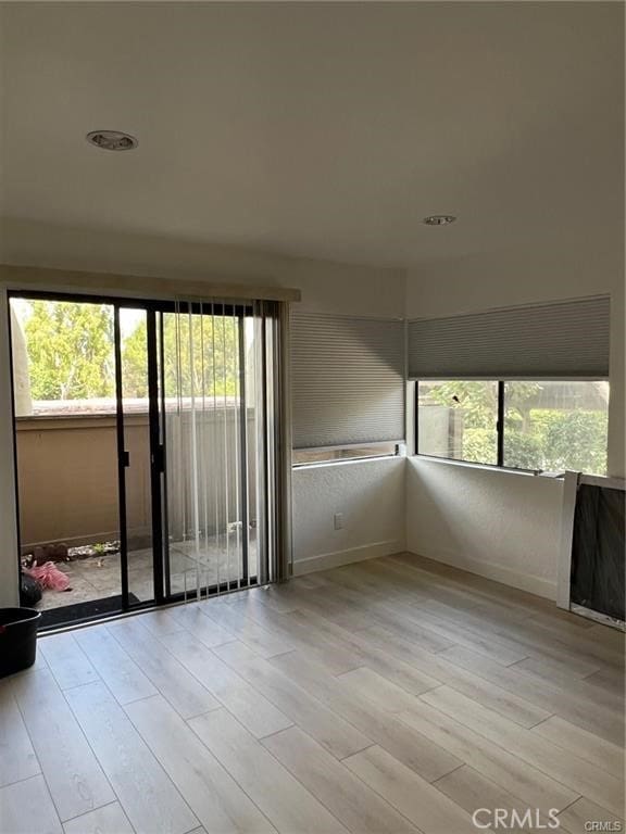 22848 Hilton Head Dr Unit 179, Diamond Bar, CA 91765 - empty room featuring baseboards, a wealth of natural light, and light wood finished floors