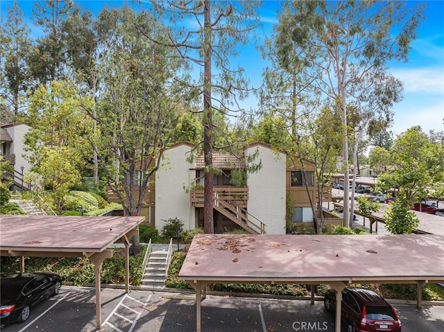 22848 Hilton Head Dr Unit 179, Diamond Bar, CA 91765 - view of building exterior with stairway and covered and uncovered parking