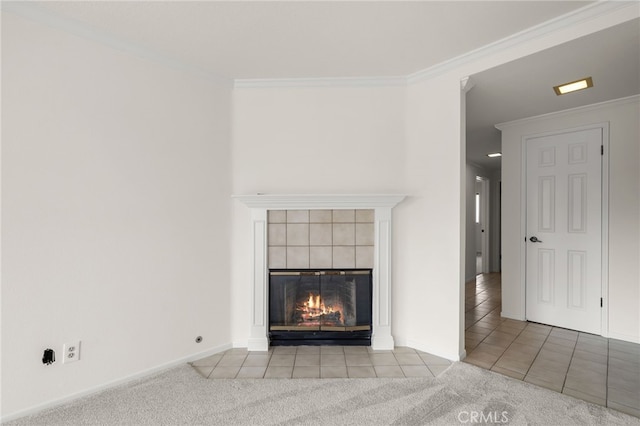 unfurnished living room featuring crown molding, a tiled fireplace, and light colored carpet