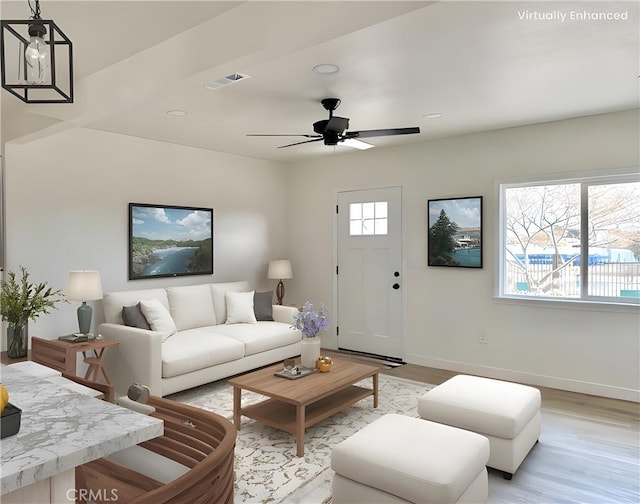 living room with ceiling fan and light hardwood / wood-style flooring