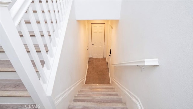 stairs featuring hardwood / wood-style flooring