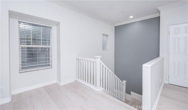 staircase featuring wood-type flooring and ornamental molding