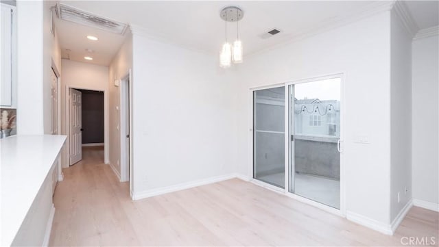 interior space featuring ornamental molding and light wood-type flooring