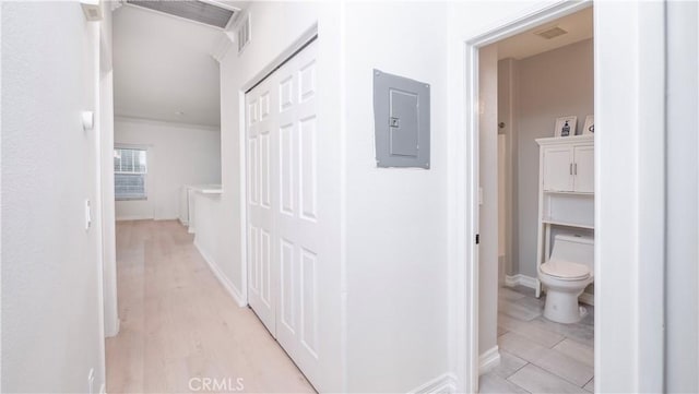 hall featuring electric panel and light hardwood / wood-style floors