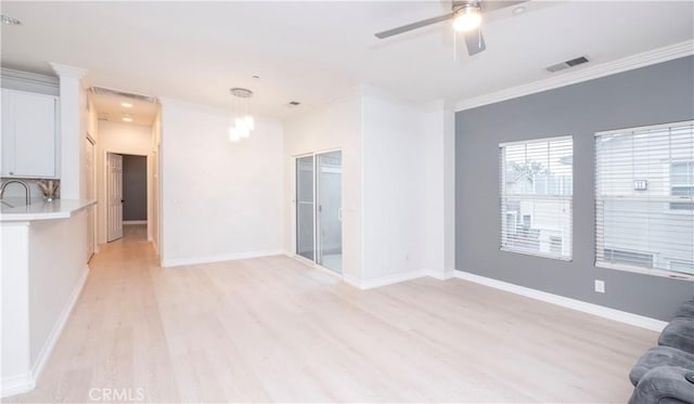 unfurnished living room with crown molding, ceiling fan with notable chandelier, and light hardwood / wood-style floors