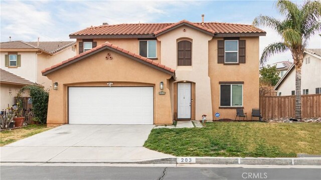 mediterranean / spanish-style home with a garage and a front yard