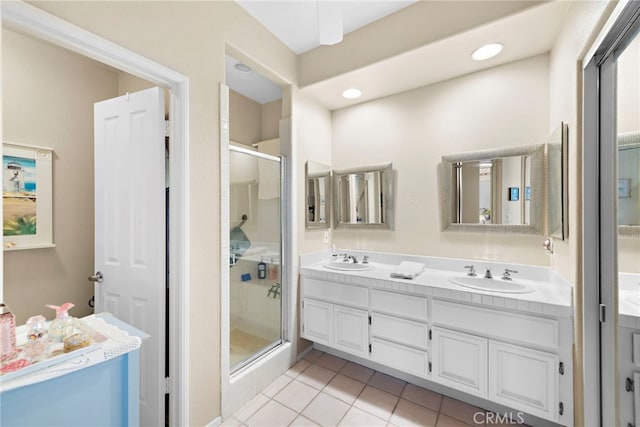 bathroom featuring walk in shower, vanity, and tile patterned flooring