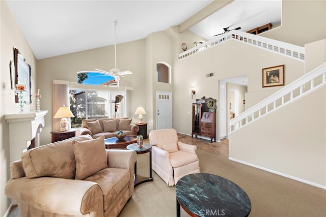 carpeted living room with ceiling fan, beamed ceiling, and high vaulted ceiling