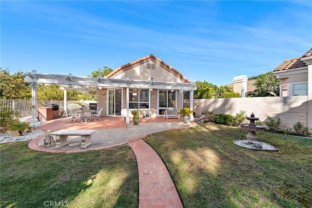 rear view of house with a patio area, a lawn, and a pergola