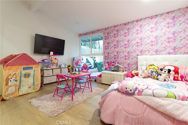 bedroom with wood-type flooring and lofted ceiling with beams