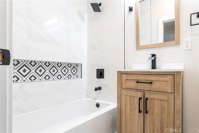 bathroom with vanity and tiled shower / bath