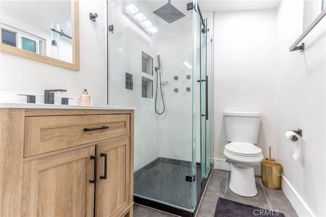 bathroom featuring toilet, vanity, and an enclosed shower