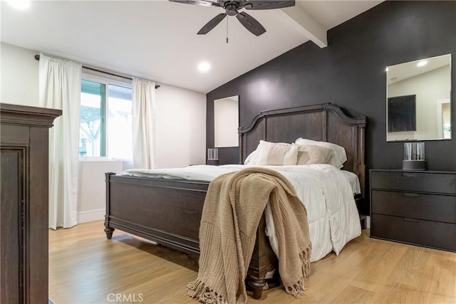 bedroom with light hardwood / wood-style floors, vaulted ceiling with beams, and ceiling fan