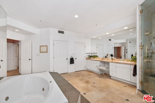 bathroom with vanity and independent shower and bath