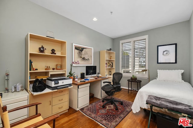 bedroom with wood-type flooring