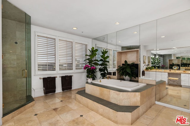 bathroom featuring tile patterned floors, vanity, and separate shower and tub