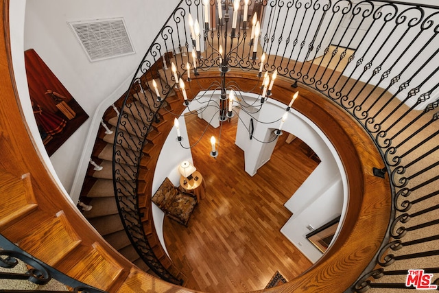 staircase with a chandelier