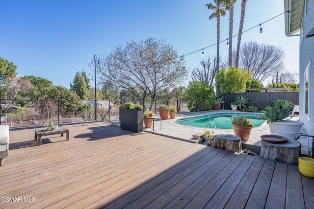 wooden terrace with a fenced in pool