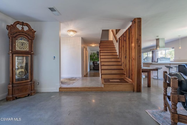 staircase with concrete floors