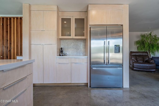 kitchen with tasteful backsplash, built in fridge, and light brown cabinetry