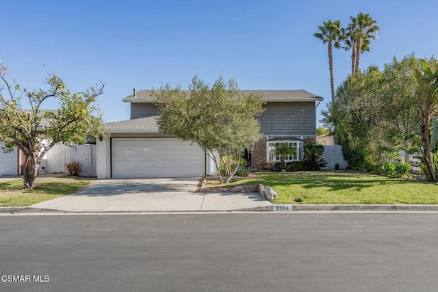 view of front of property featuring a garage and a front yard