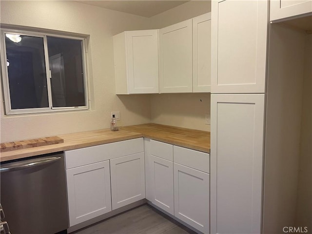 kitchen featuring white cabinetry, dishwasher, dark wood-type flooring, and butcher block countertops